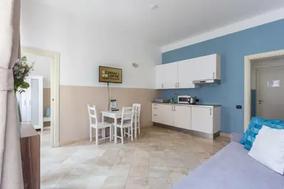 a kitchen and living room with a table and chairs at Legerova 33 Apartments in Prague