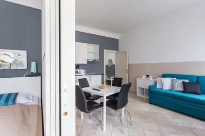 a living room with a table and chairs and a couch at Legerova 33 Apartments in Prague