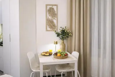 a white table with a bowl of fruit on it at D&D Apartment Moderní apartmán v centru Prahy in Prague