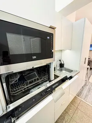 a microwave oven in a kitchen with a sink at D&D Apartment Moderní apartmán v centru Prahy in Prague