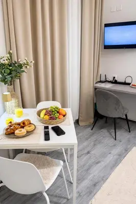 a white table with a bowl of fruit on it at D&D Apartment Moderní apartmán v centru Prahy in Prague