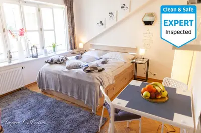 a bedroom with a bed and a table with a bowl of fruit at Old Town Square Apartment in Prague