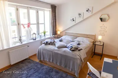 a bedroom with a bed with pillows on it at Old Town Square Apartment in Prague