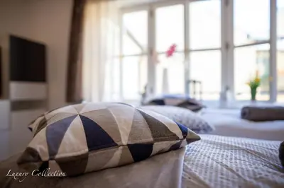 a pillow sitting on a bed in a room at Old Town Square Apartment in Prague
