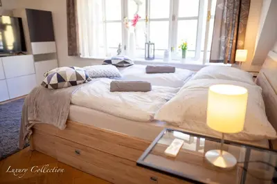 a large bed in a room with a glass table at Old Town Square Apartment in Prague