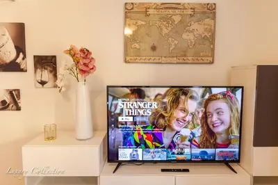 a flat screen tv sitting on a stand in a living room at Old Town Square Apartment in Prague