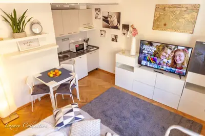 a small living room with a small table and a kitchen at Old Town Square Apartment in Prague