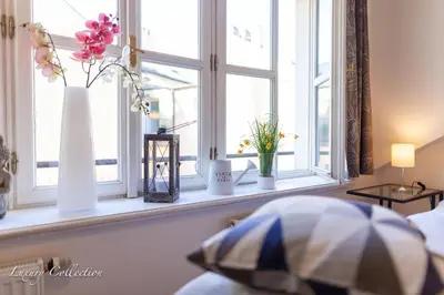 a window sill with vases and flowers on it at Old Town Square Apartment in Prague