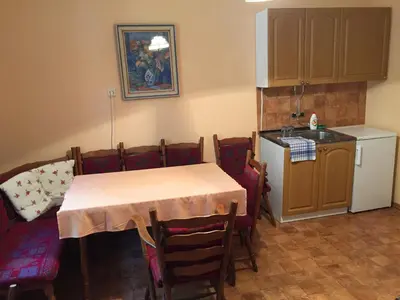 a kitchen with a table and chairs and a kitchen with a sink at Zámek Lobeč in Lobeč