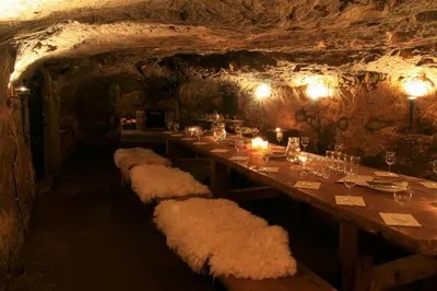 a long dining room with a long table in a cave at Zámek Lobeč in Lobeč