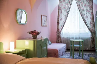 a bedroom with two beds and a window at Zámek Lobeč in Lobeč