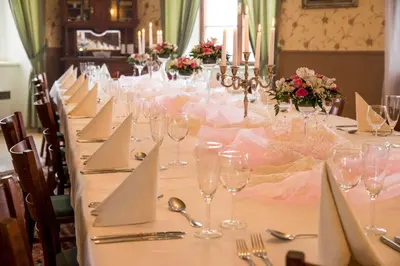 a long table with wine glasses and napkins on it at Zámek Lobeč in Lobeč