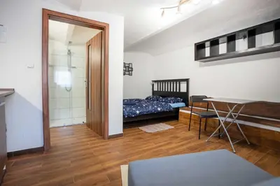 a room with a bed and a table in it at U báby Šubrový in Kokořín