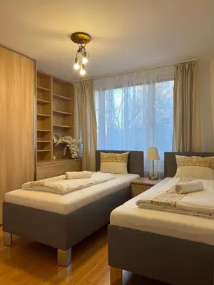 a bedroom with two beds and a window at Cozy City Stay - Central Apartment in Prague