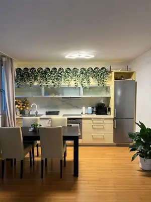 a kitchen with a table and a refrigerator at Cozy City Stay - Central Apartment in Prague
