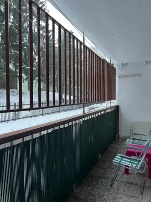 a balcony with two chairs and a large window at Cozy City Stay - Central Apartment in Prague
