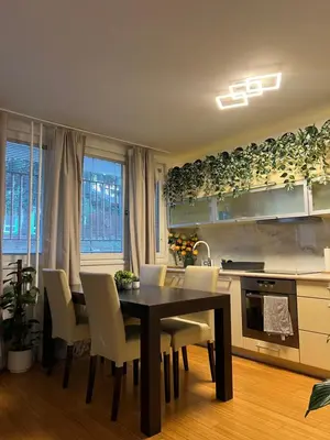 a kitchen with a dining room table and chairs at Cozy City Stay - Central Apartment in Prague