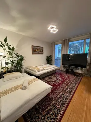 a living room with two beds and a flat screen tv at Cozy City Stay - Central Apartment in Prague