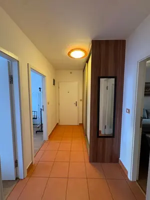 an empty hallway with a door and a tile floor at Cozy City Stay - Central Apartment in Prague
