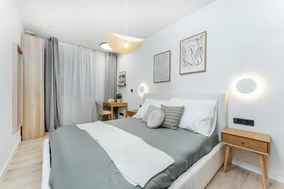 a bedroom with a large bed and a window at Rentero Riverside Serenity Residence - Prague 7 in Prague