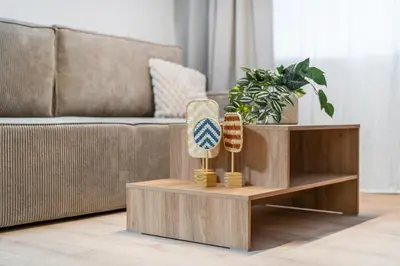 a coffee table in a living room with a couch at Rentero Riverside Serenity Residence - Prague 7 in Prague