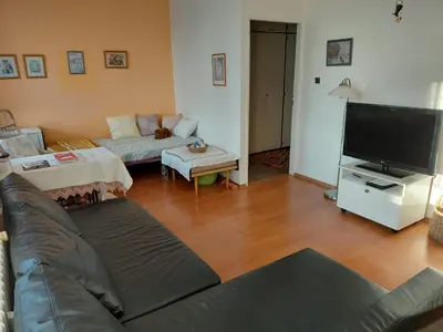 a living room with a couch and a flat screen tv at At the Star in Kladno