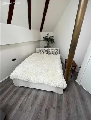 a bedroom with a white bed and a wooden floor at Room for 2 in Central Prague 8 Apartment in Prague