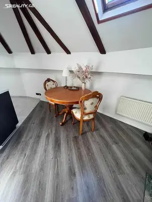 a room with a wooden table and chairs and a room with a ceiling at Room for 2 in Central Prague 8 Apartment in Prague