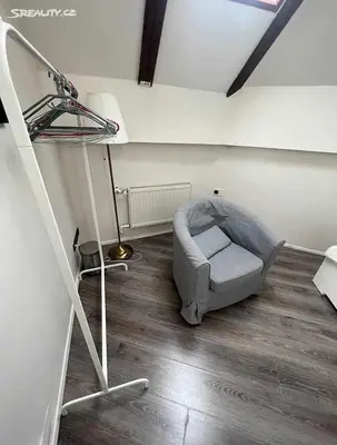a room with a chair in the corner of a room at Room for 2 in Central Prague 8 Apartment in Prague