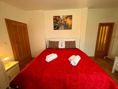 a bedroom with a bed and a dresser at Charming Apartment Klimentska in Prague