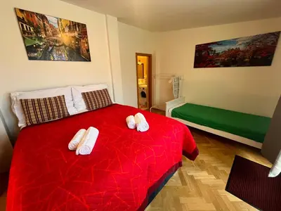 a living room with a couch with red pillows at Charming Apartment Klimentska in Prague