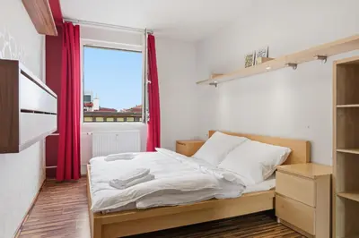 a small bedroom with a bed and a window at Apartment in a quiet part of Prague with a kitchen in Prague