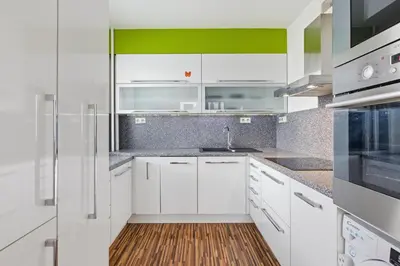 a white kitchen with white cabinets and a sink at Apartment in a quiet part of Prague with a kitchen in Prague