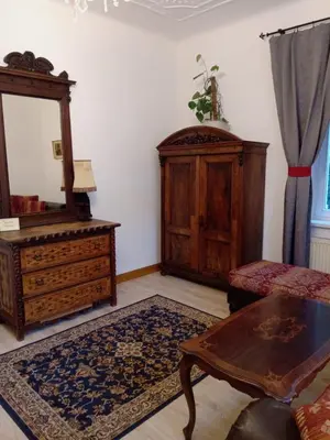 a living room with a dresser and a mirror at Historic Villa Apartments in Prague