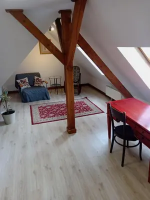 a living room with a table and a couch at Historic Villa Apartments in Prague