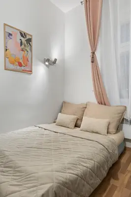 a bed in a white room with a window at Boutique Loft Prague in Prague