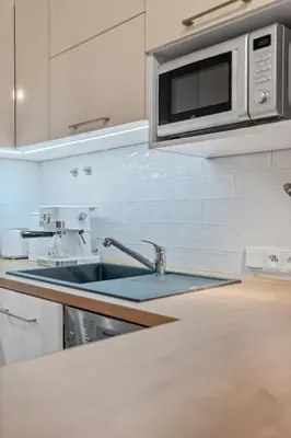 a kitchen with a sink and a microwave at Boutique Loft Prague in Prague