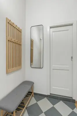 a mirror and a bench next to a door at Boutique Loft Prague in Prague