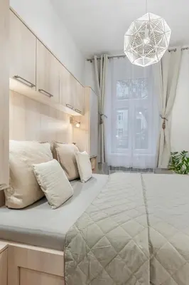 a large white bed in a room with a window at Boutique Loft Prague in Prague