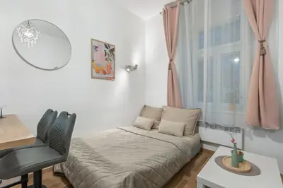 a bedroom with a bed and a desk and a window at Boutique Loft Prague in Prague