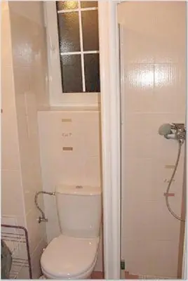 a bathroom with a toilet and a window at Hostel Bell in Prague