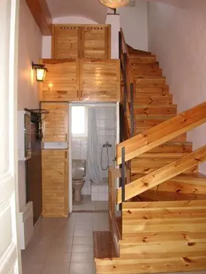 a staircase in a bathroom with a toilet and a stair case at Hostel Bell in Prague