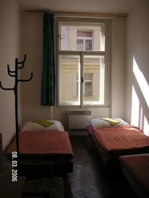 a room with two beds and a window at Hostel Bell in Prague