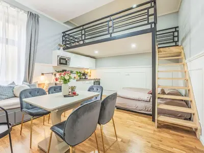 a room with a table and chairs and a bunk bed at Apartment Washington-6 by Interhome in Prague
