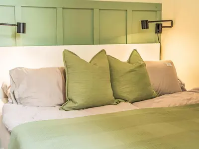 a bed with four pillows on top of it at Apartment Washington-6 by Interhome in Prague