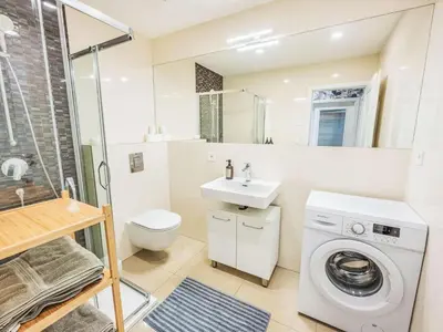 a bathroom with a washing machine and a sink at Apartment Washington-6 by Interhome in Prague
