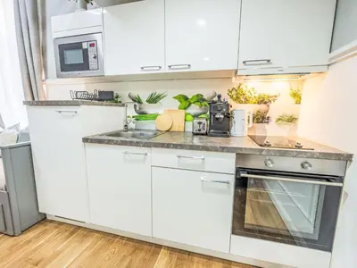 a kitchen with white cabinets and a counter top at Apartment Washington-6 by Interhome in Prague