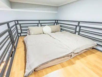 a bed on a metal bed frame in a room at Apartment Washington-6 by Interhome in Prague