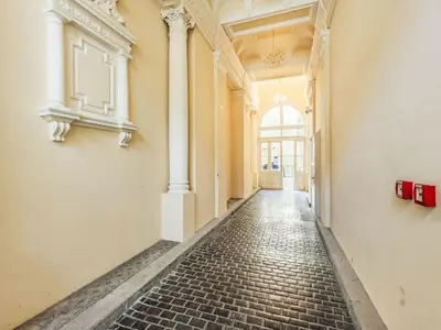 an empty hallway of a building with a brick floor at Apartment Washington-6 by Interhome in Prague