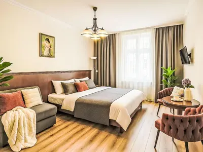 a hotel room with a bed and a couch at Studio Balbin by Interhome in Prague